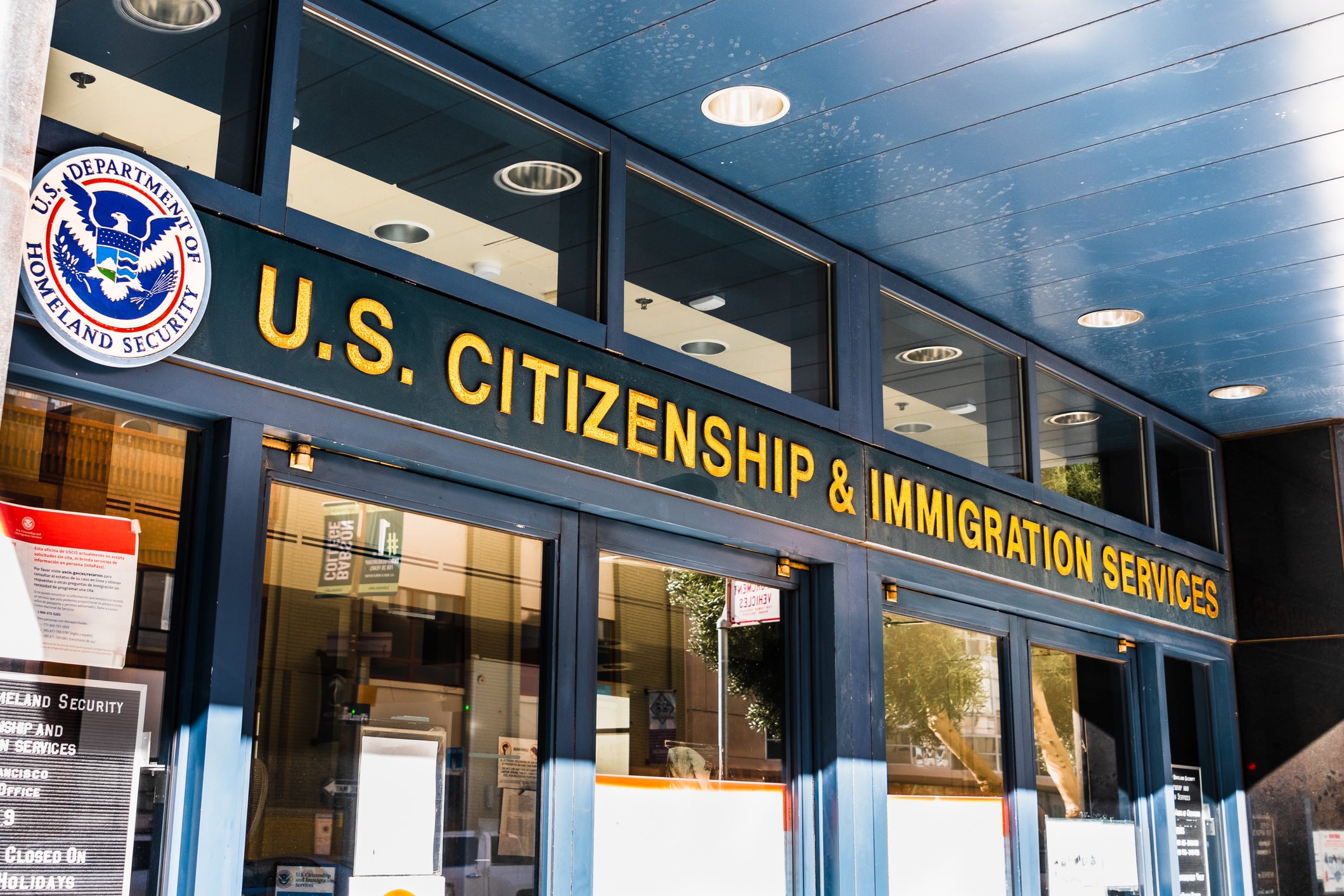 Building with glass doors, sign above the doors reads, U.S. Citizenship and Immigration Services.