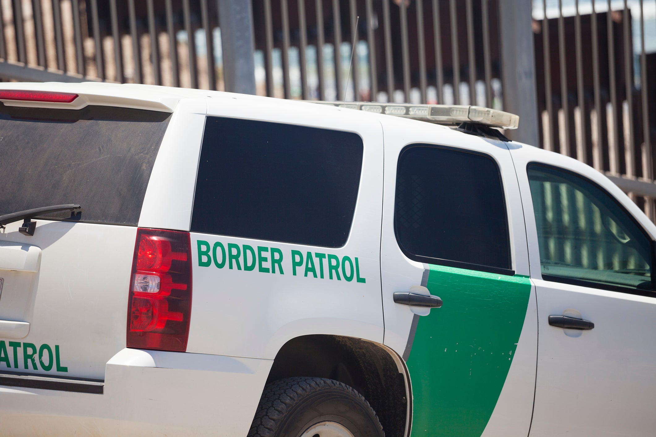 Border patrol car at the US border with Mexico in San Diego with the fence behind.