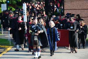 Dean Martha Minow walking with graduates