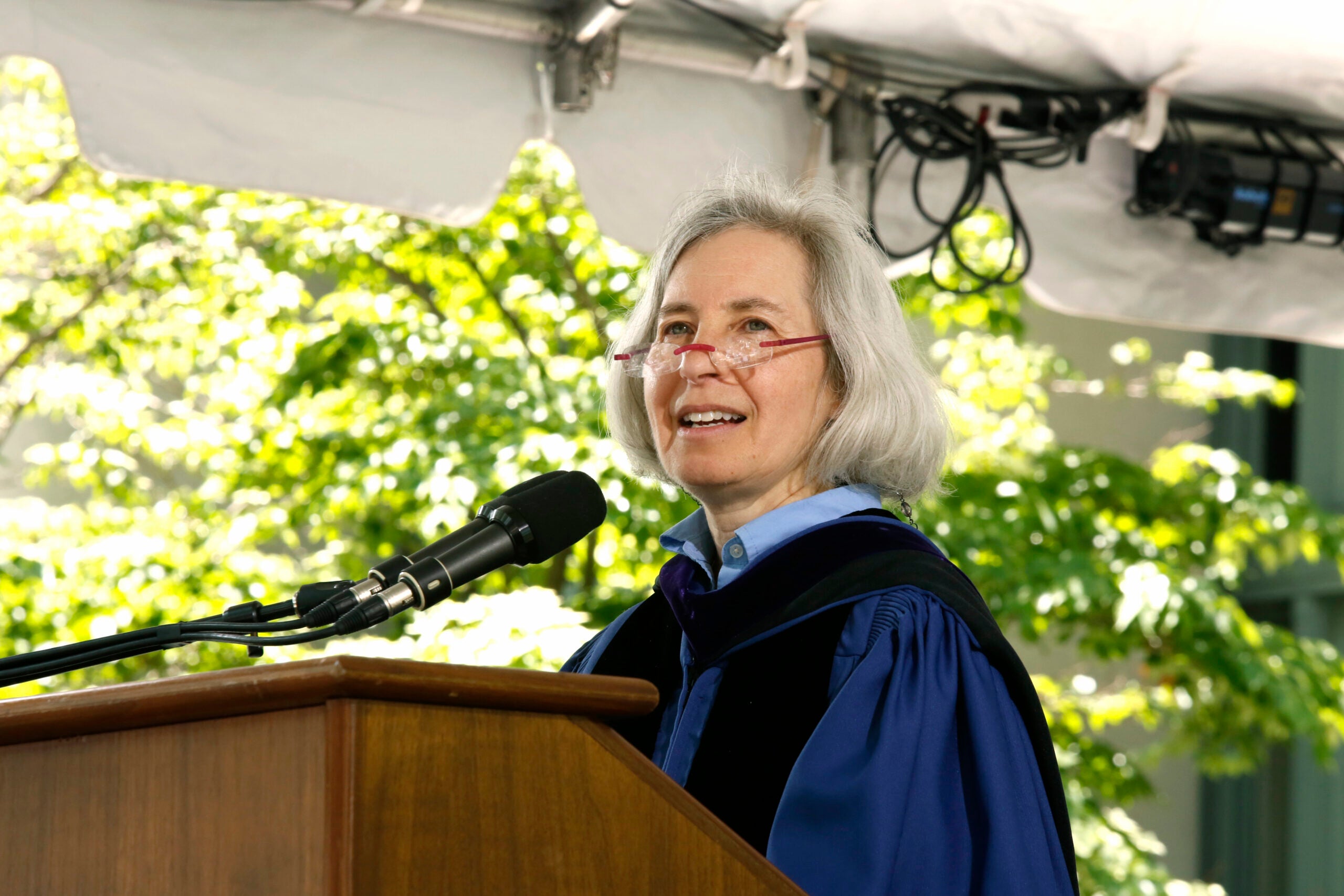 Martha Minow in blue gown speaking at commencement