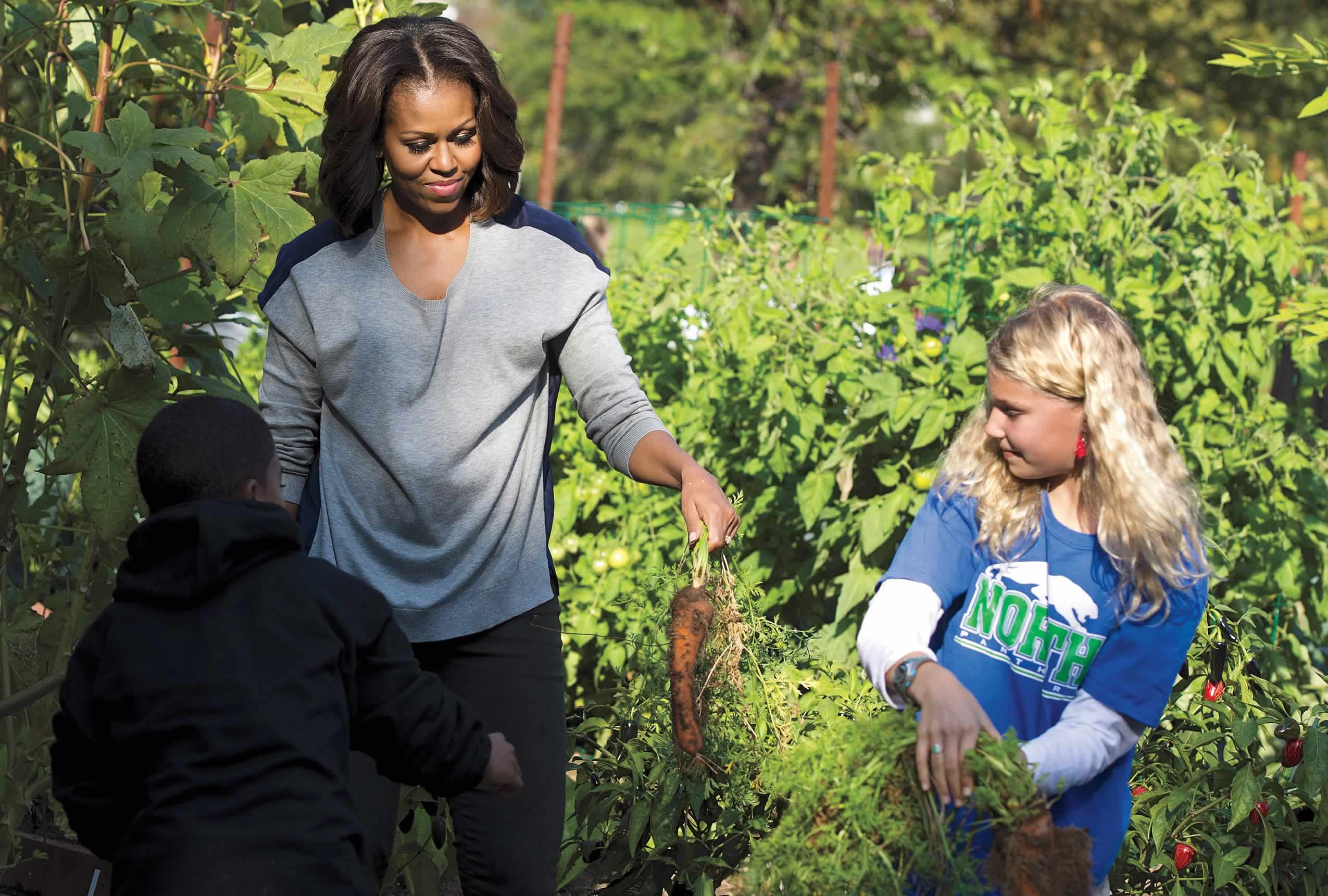First lady Michelle Obama in the White House Kitchen Garden with local elementary school students