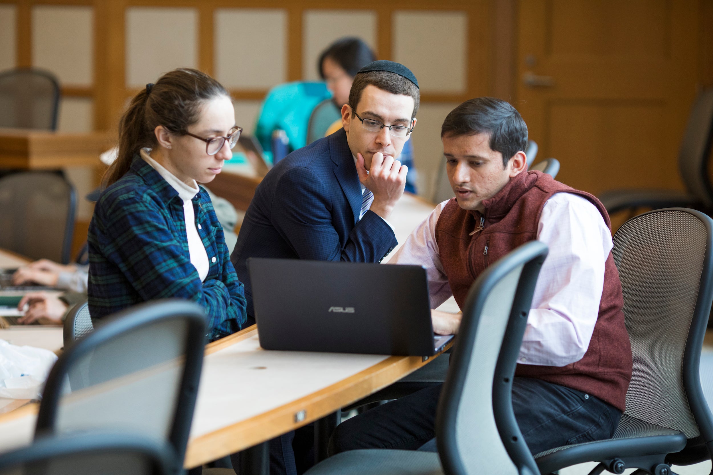 students gathered around a computer