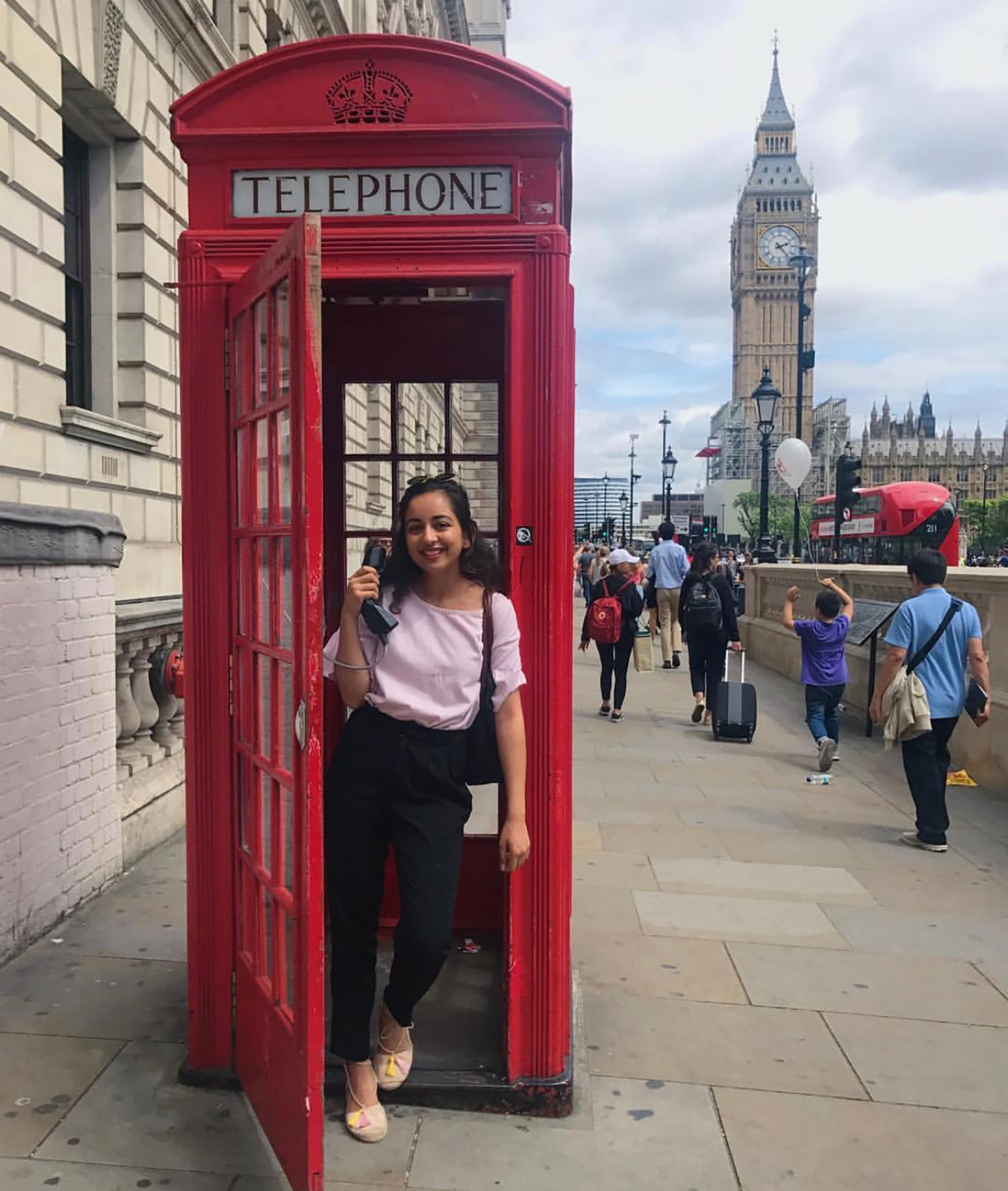 Hina Uddin poses in a telephone booth in London