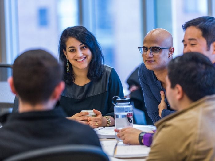 A group of people talking at a table