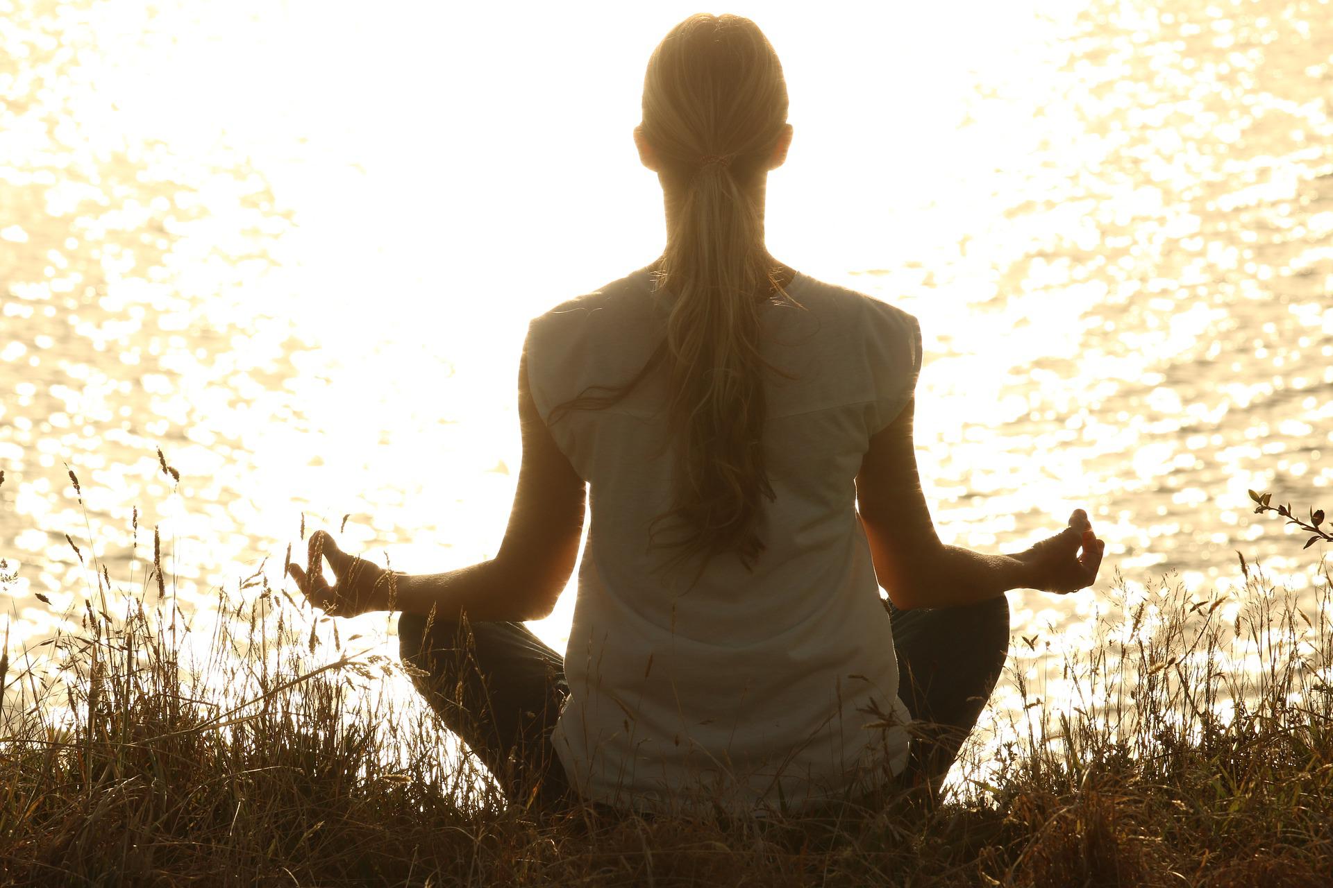 woman meditating at dusk