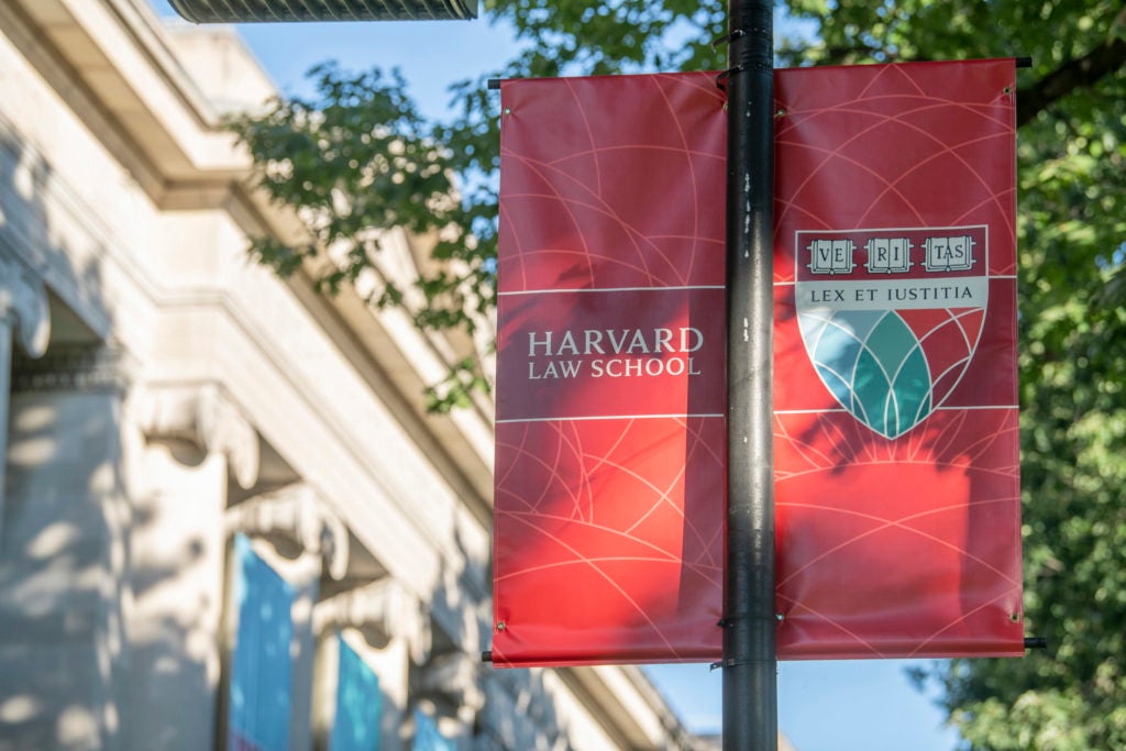 Harvard Law School banners with Landgell Hall in the background.