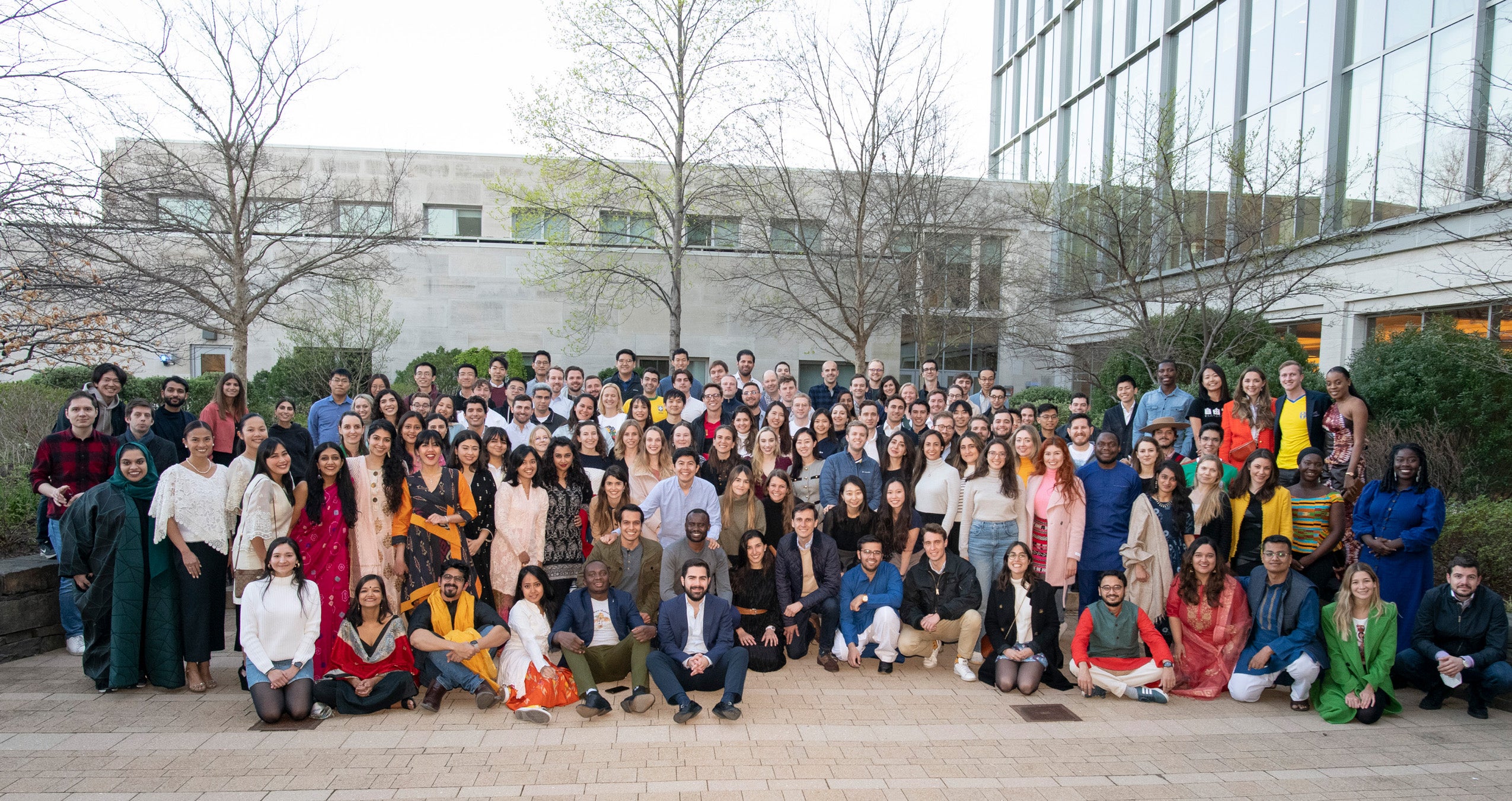 A large group of students outside at Harvard Law School pose for a photo
