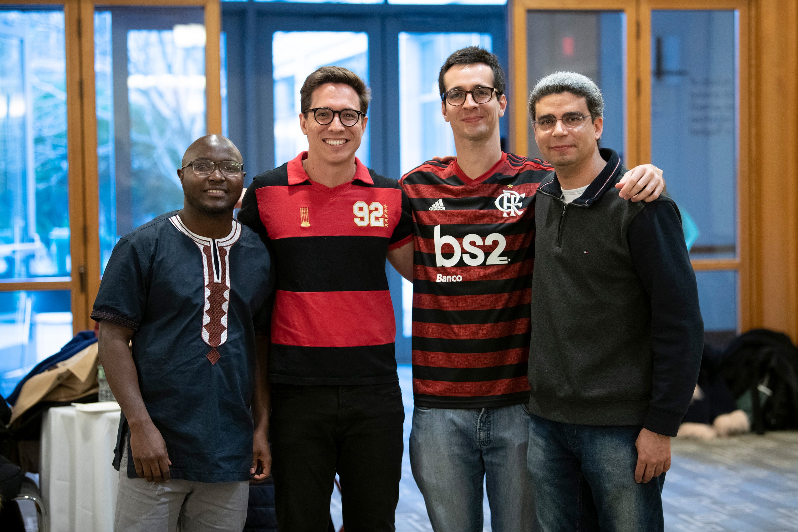 Four graduate students pose for a photo at an event.