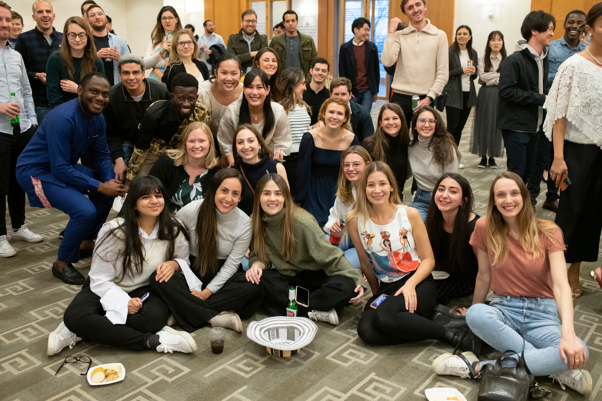 A group of smiling students pose for a photo at an event