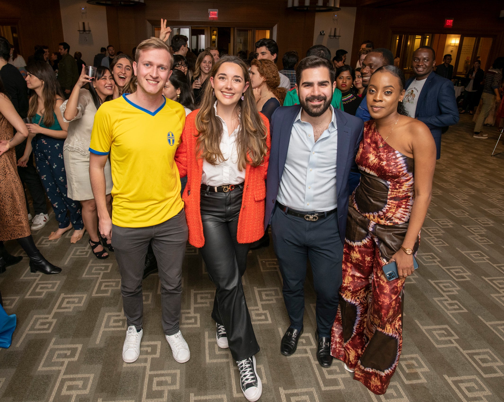 Two male and two female students pose for a photo at an event
