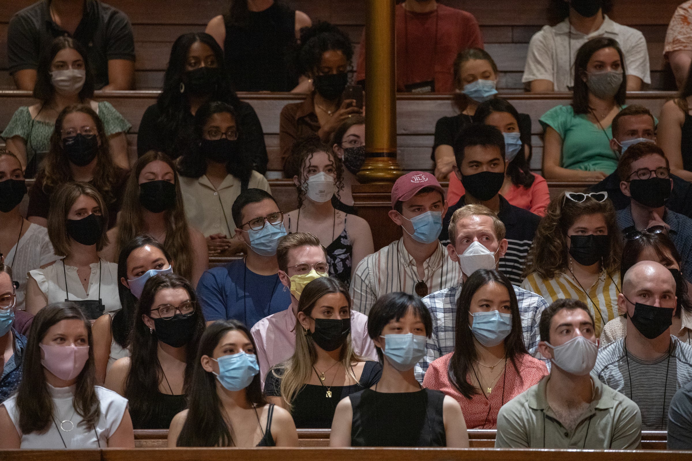 Rows of masked students sitting in rows in Sanders Theatre