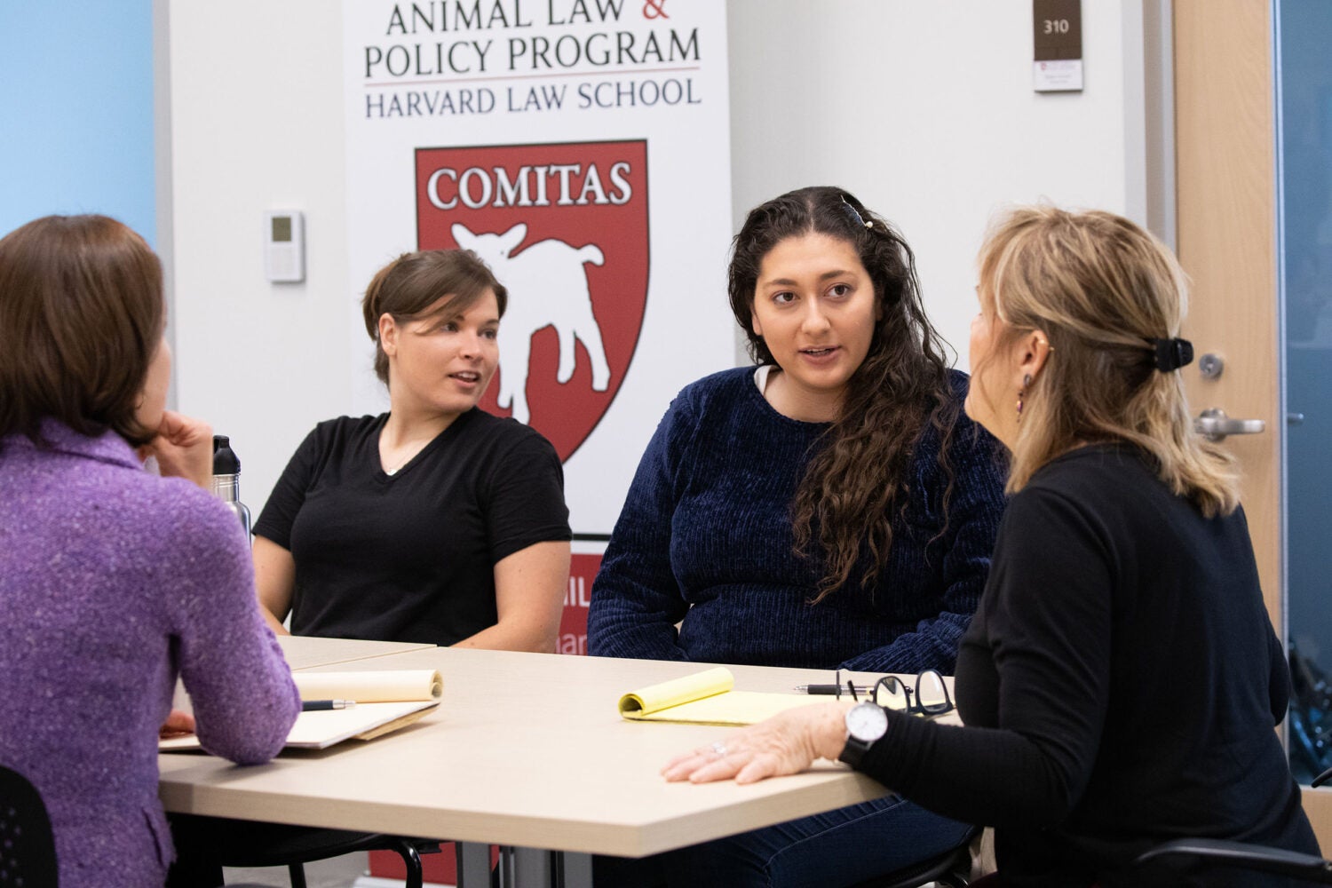 Students work around a table with their clinical instructor