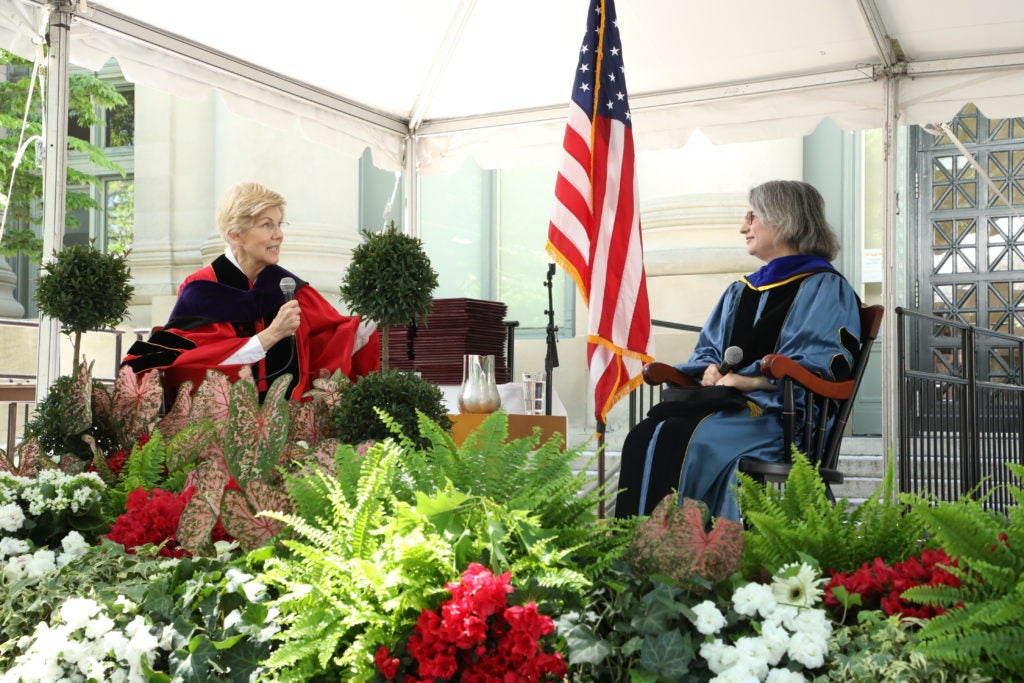 Senator Elizabeth Warren speaking on stage with Elizabeth Papp Kamali.