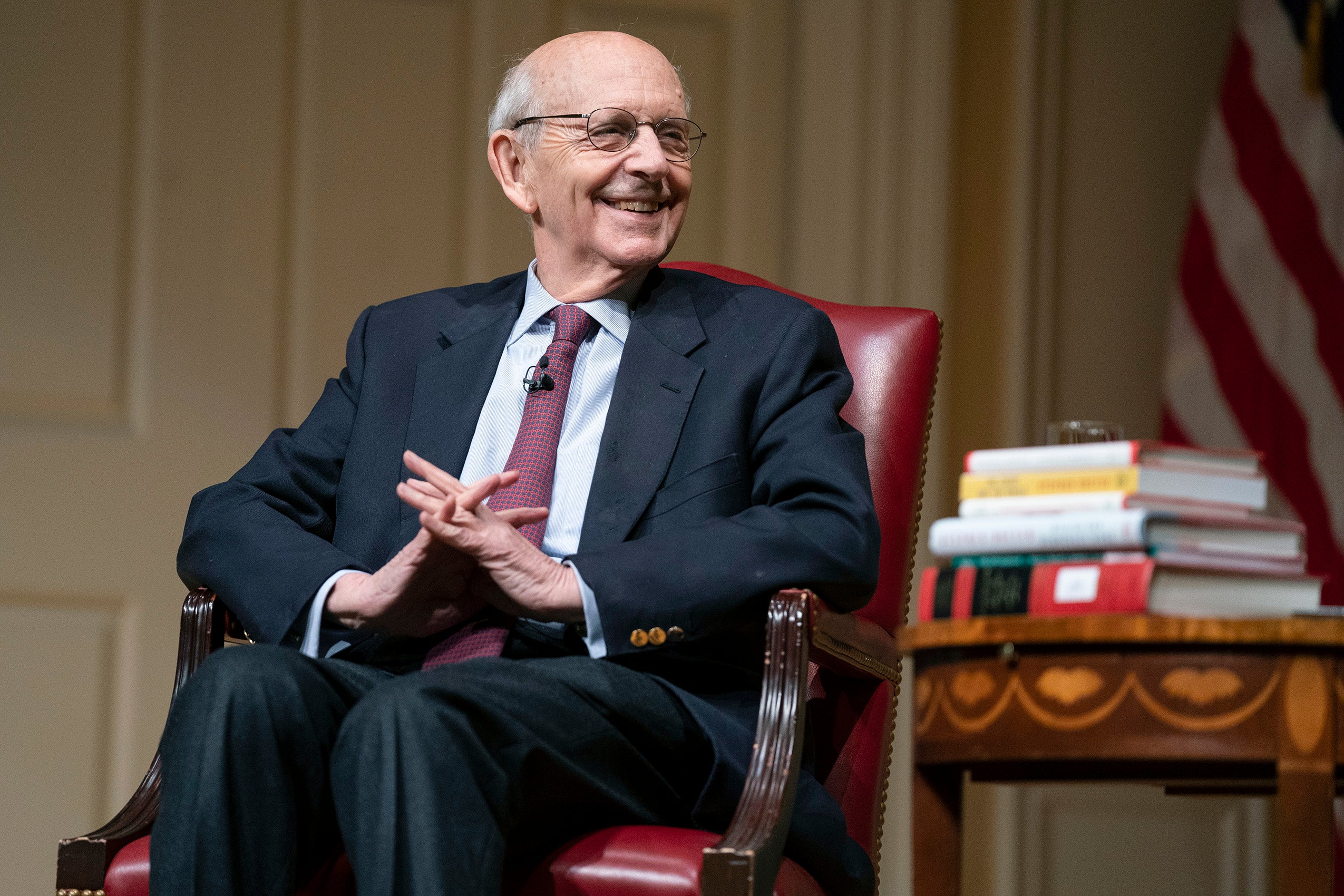 Stephen Breyer seated in a red armchair