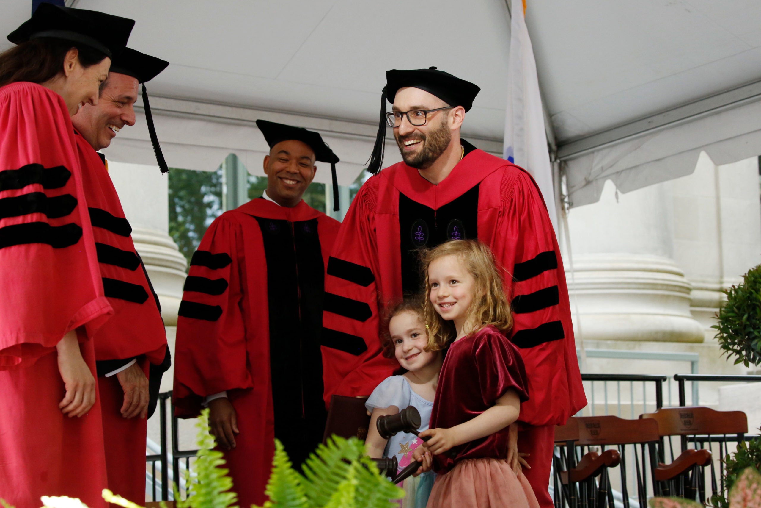 Two children go with their dad to get the diploma