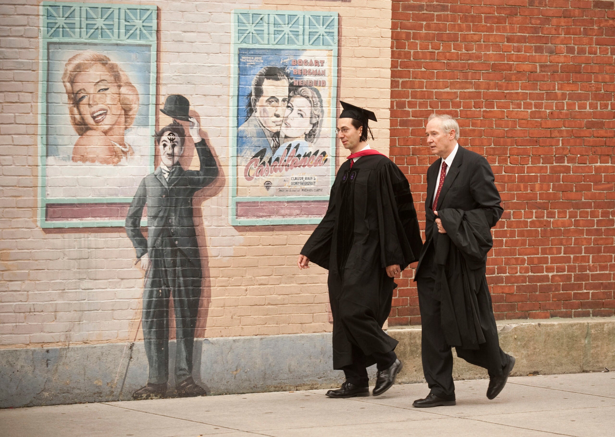 2010 graduate walks along wall
