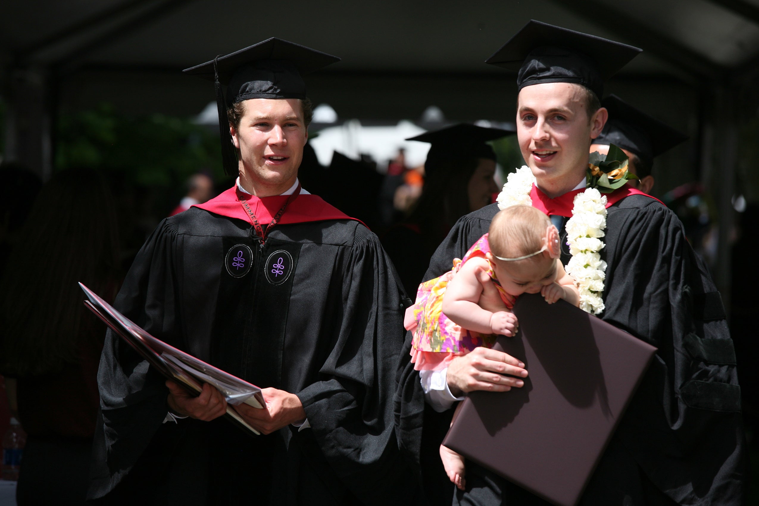two graduates in class of 2012, one with a baby