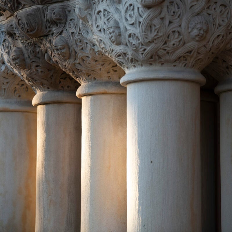 Three columns with ornate carvings at the top