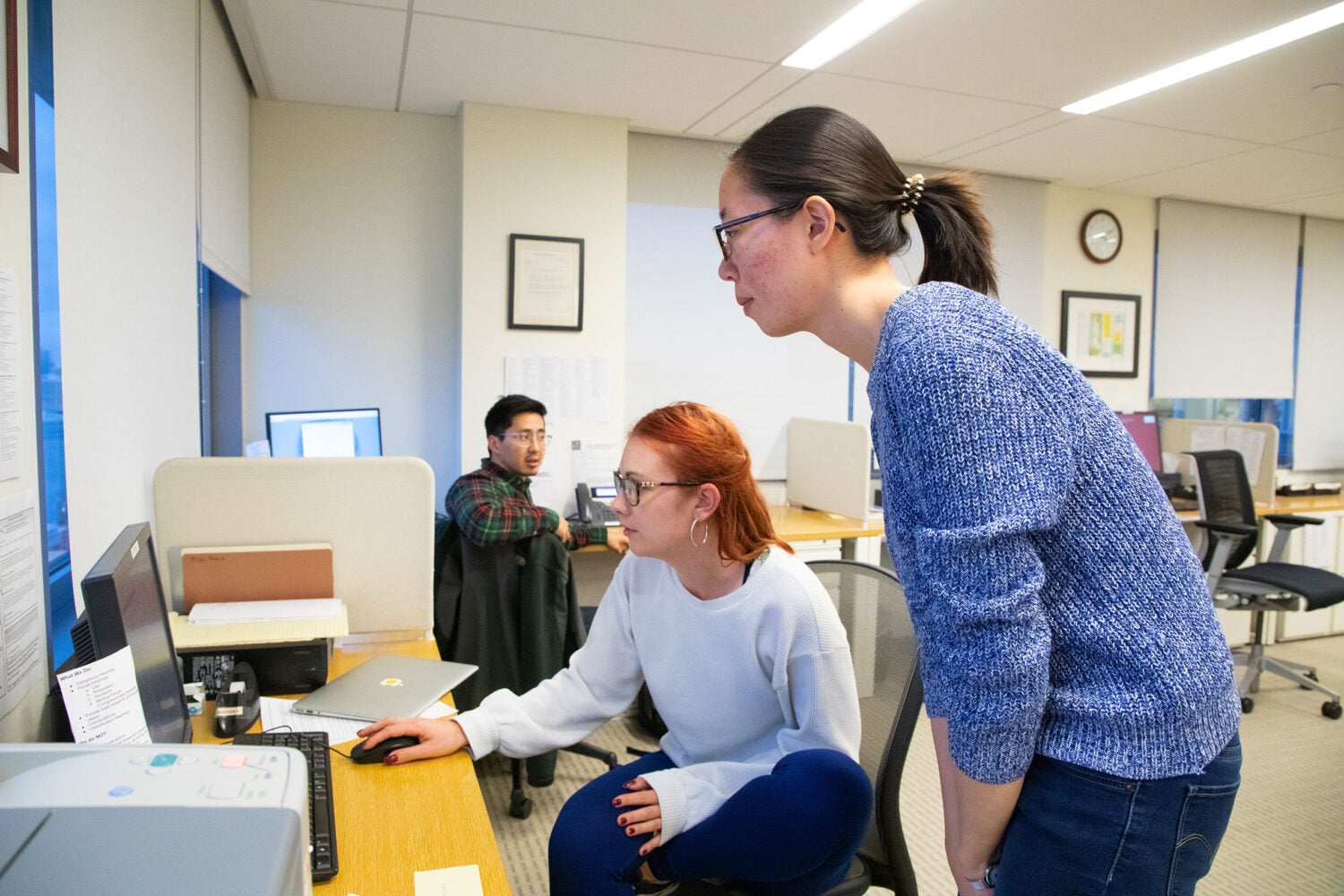 Two students looking at a computer screen.