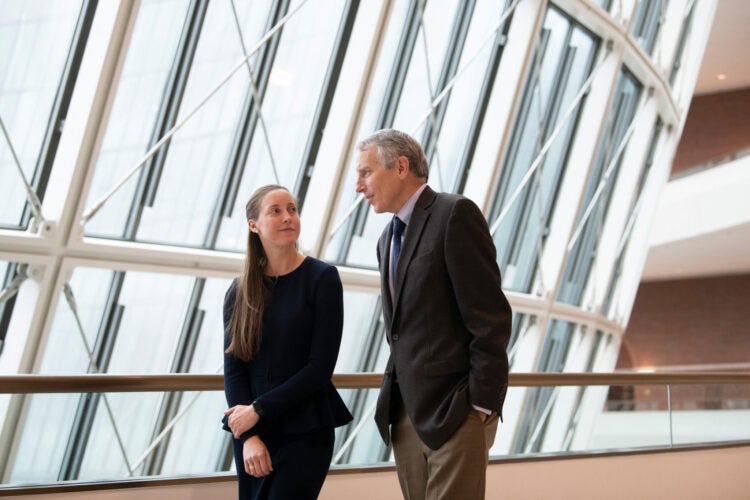 student and judge talking while walking
