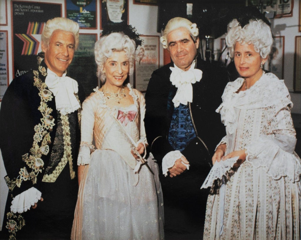 Two men and two women dressed in period opera suits or dresses