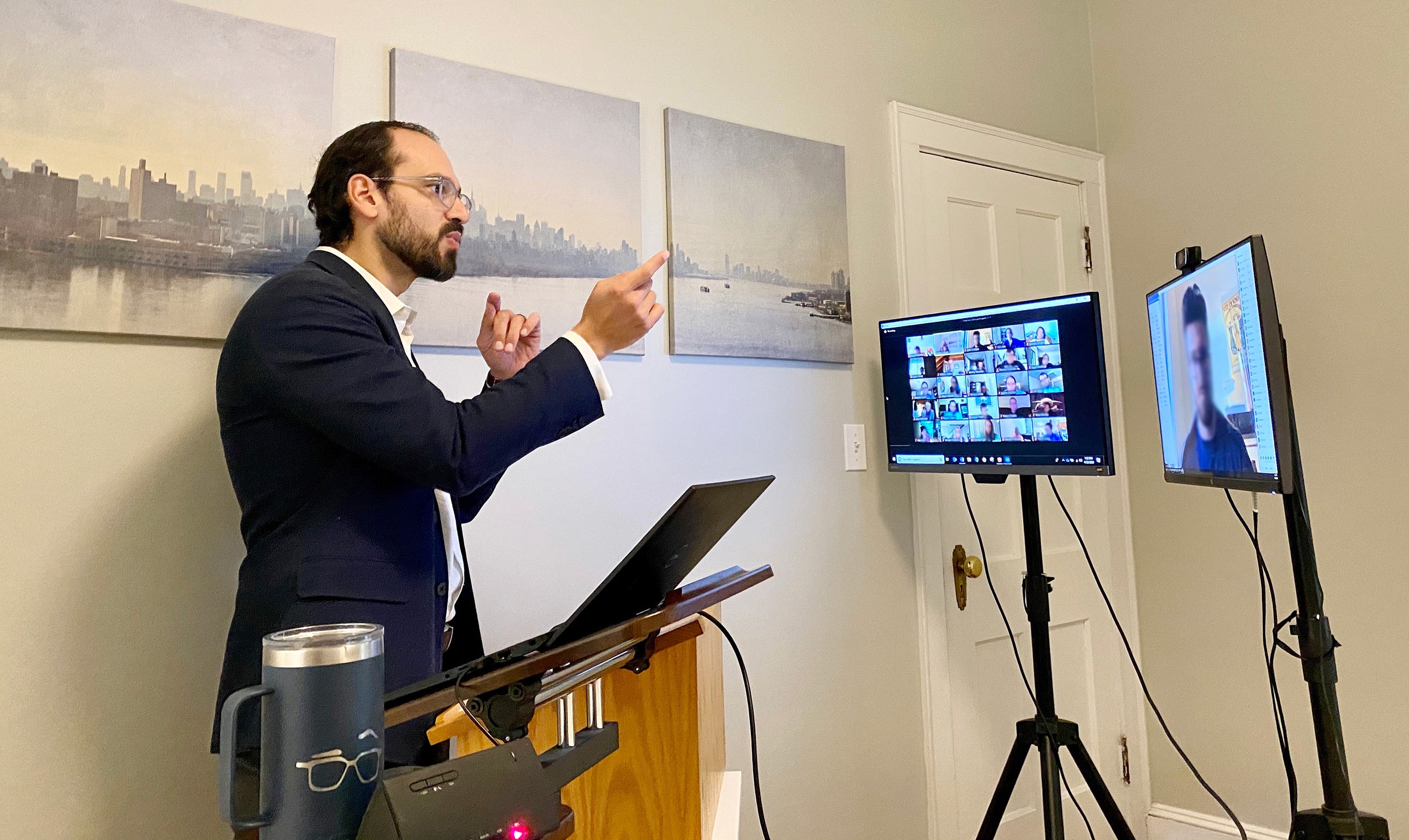Andrew Crespo works from a podium as he teaches his online class from his home