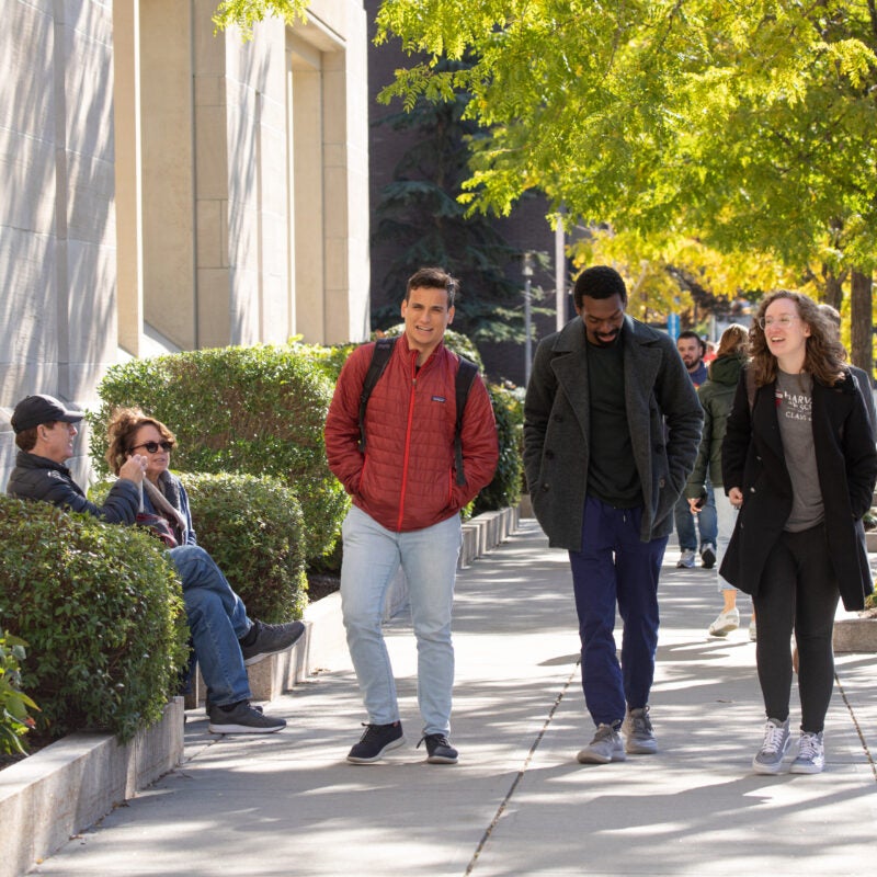 Students walking on campus in the fall