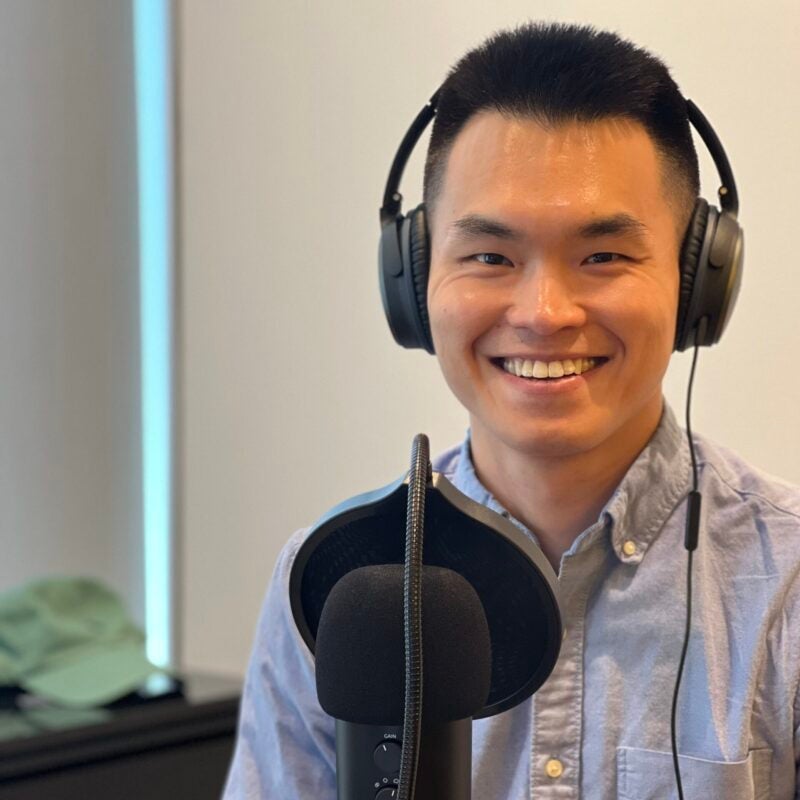 person smiling with headphones and microphone
