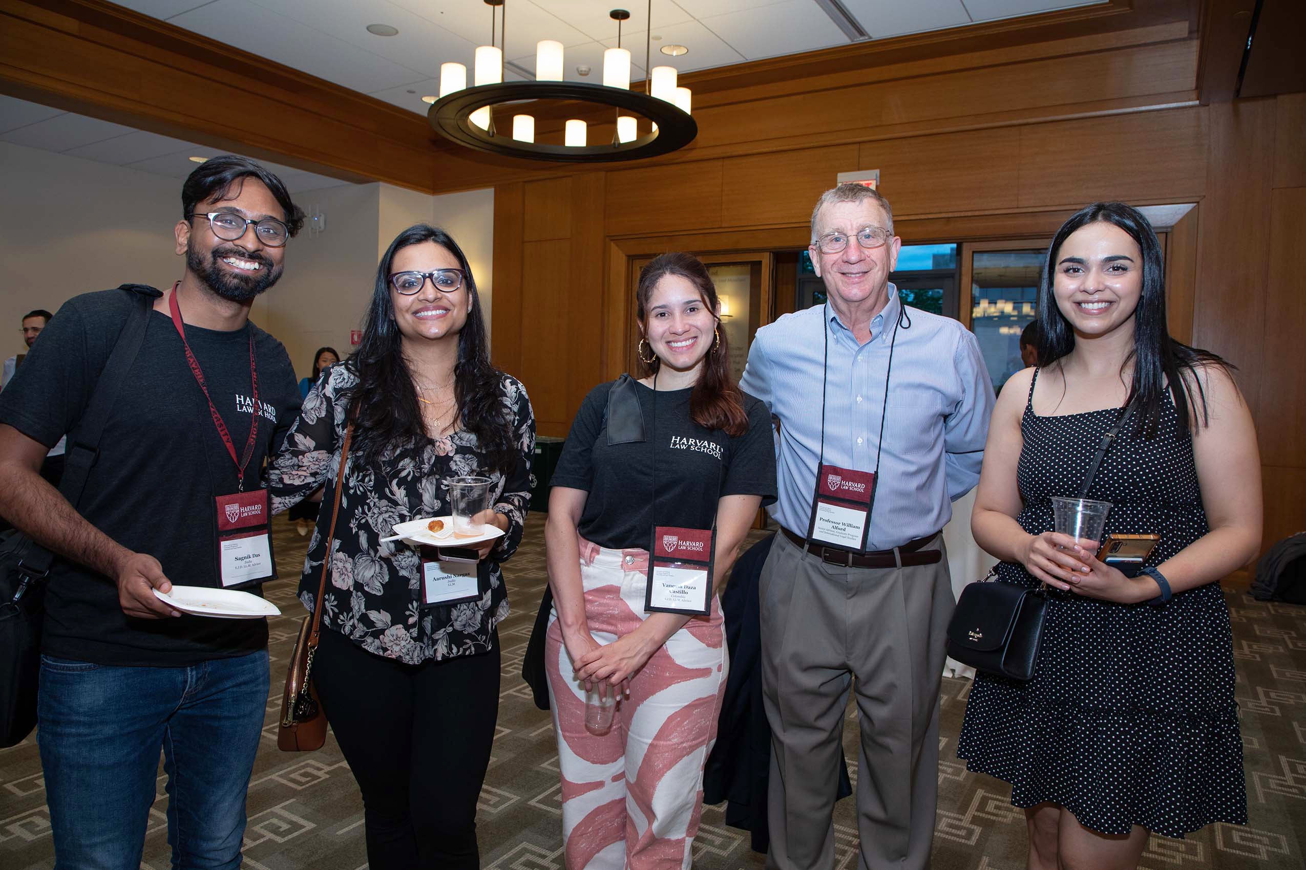 Professor Bill Alford poses with four students.