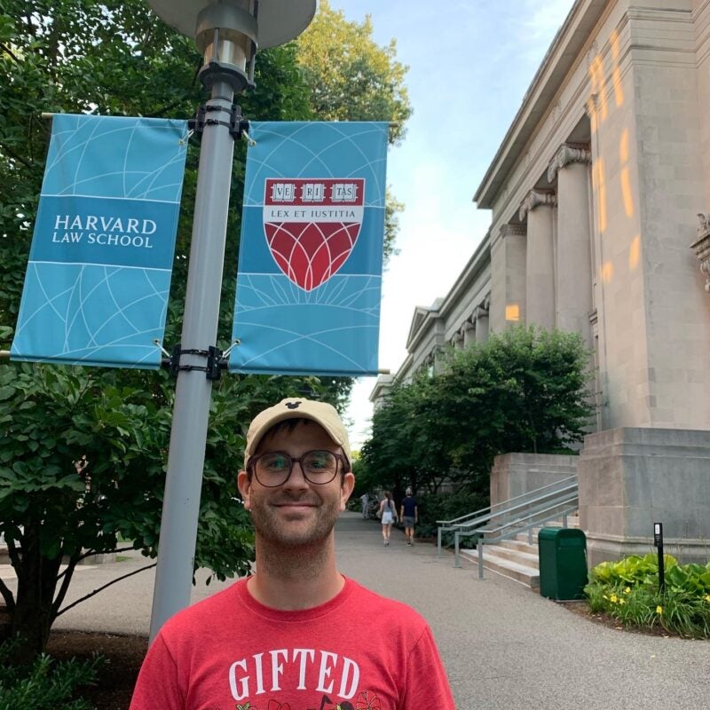man standing outside with HLS banners