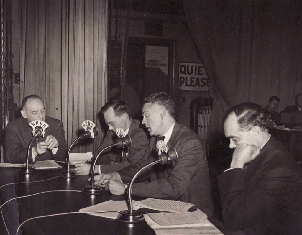 Men at a table at WHDH radio broadcast