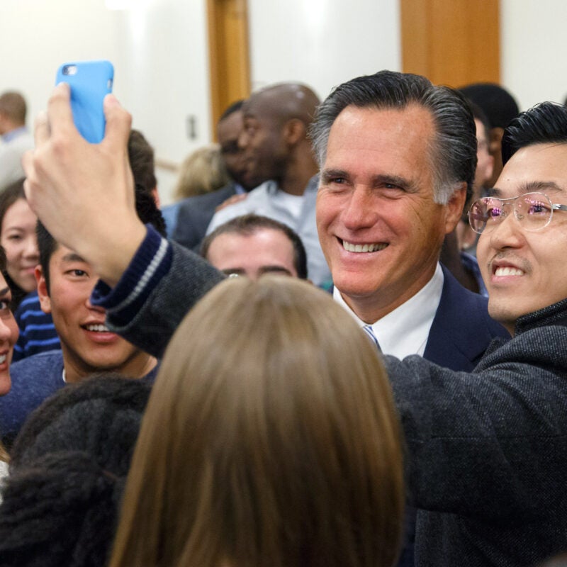 Mitt Romney taking a selfie with a student