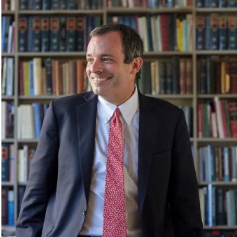 Dean Manning sitting in a library