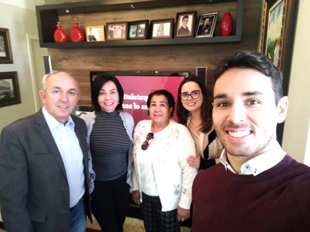 Arthur Rodrigues Dalmarco with family gathered at home