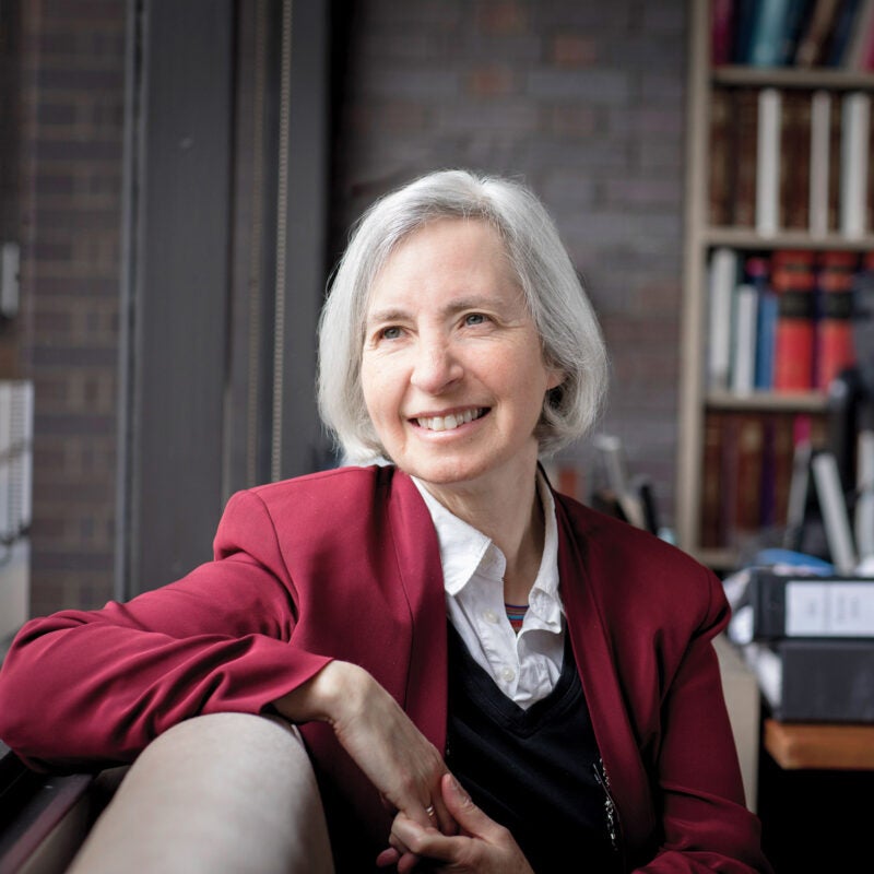 Martha Minow seated by a window in her office.