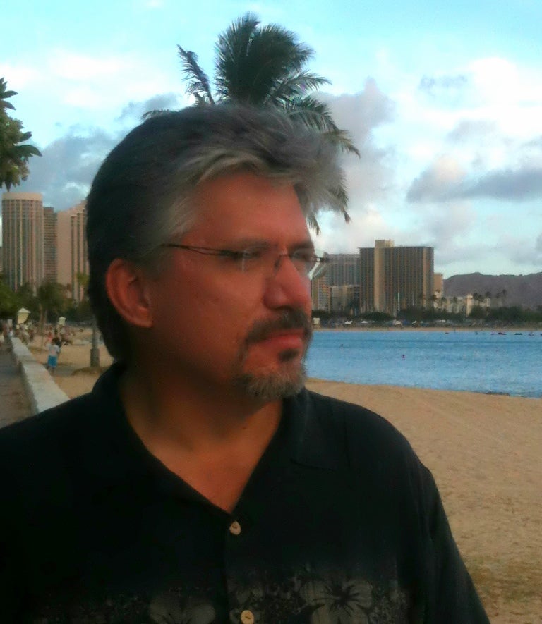 Stephen Wiles standing on a beach in Waikiki.
