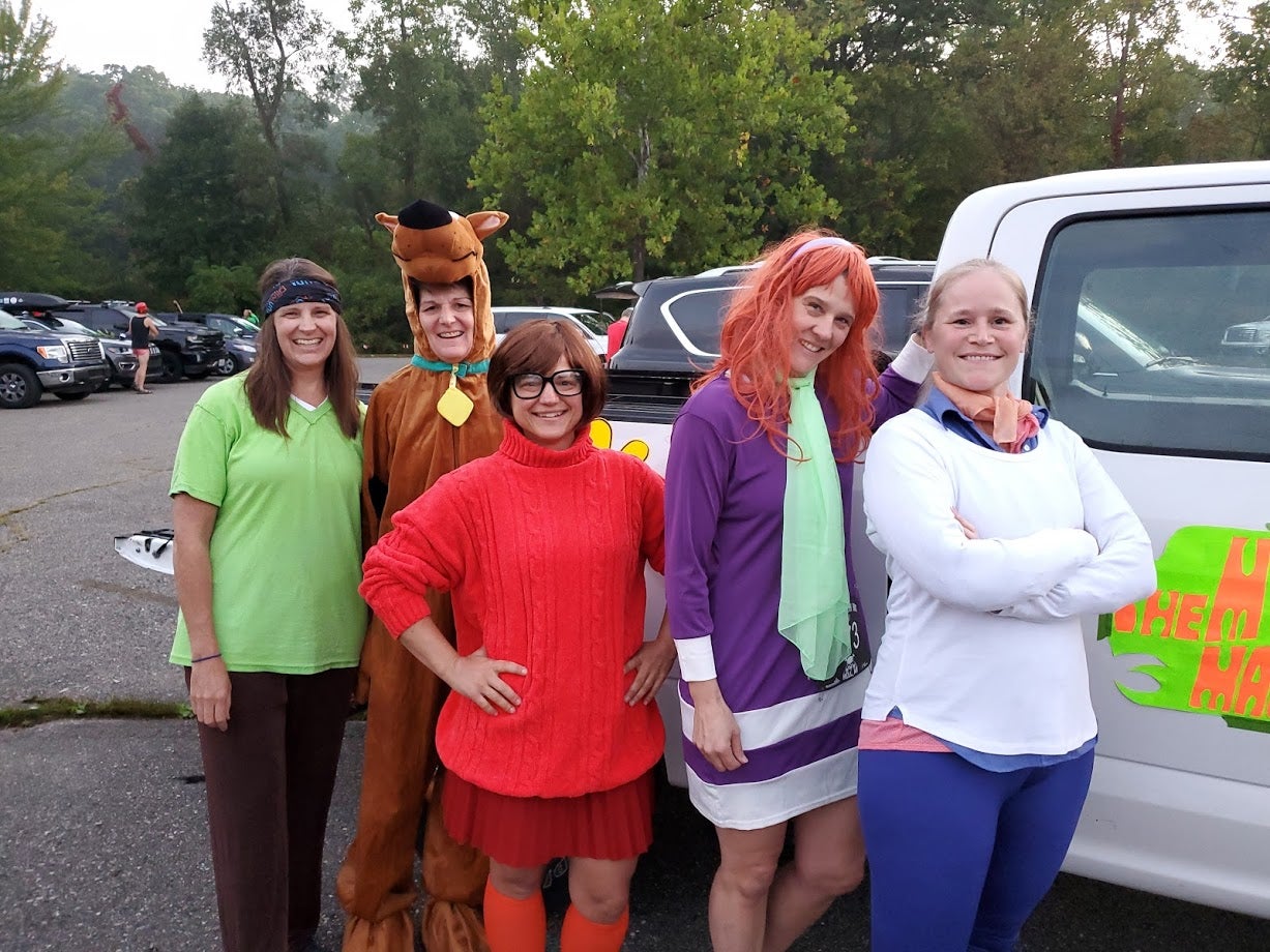 Group dressed in Scooby Gang costumes for Halloween.