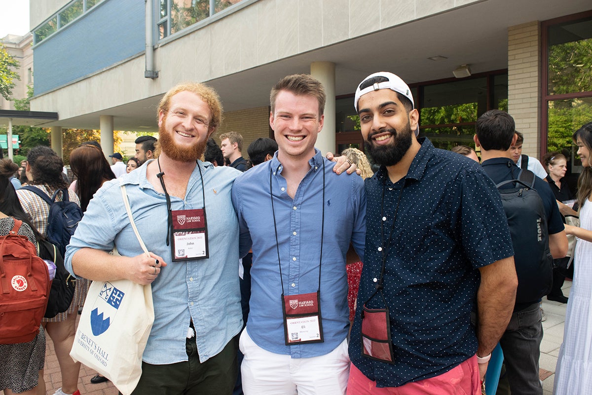 Three students pose together at orientation