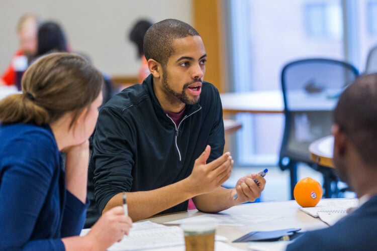 students talking at a table