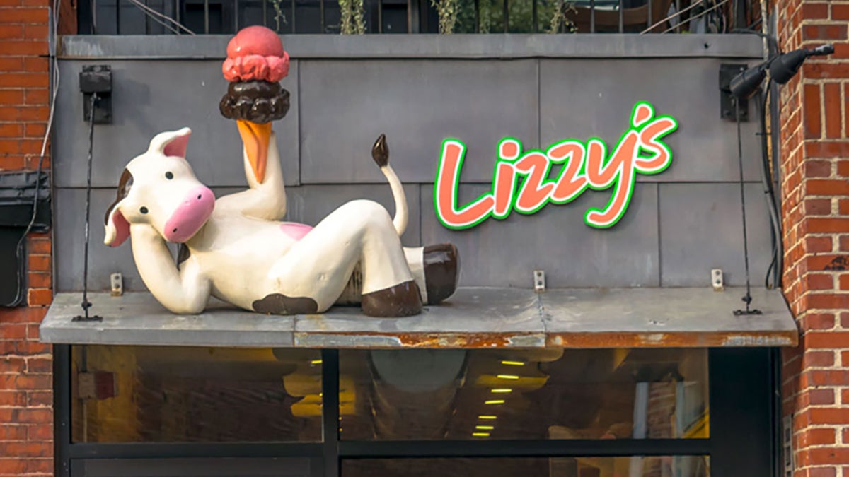 plastic cow with an ice cream cone on a Lizzy's sign