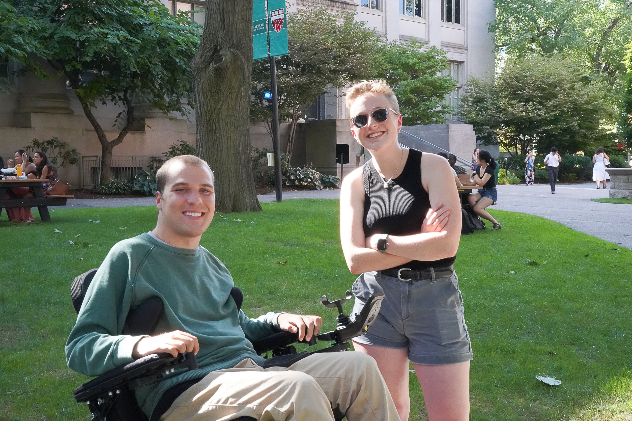 Two students standing outside, smiling for the camera.