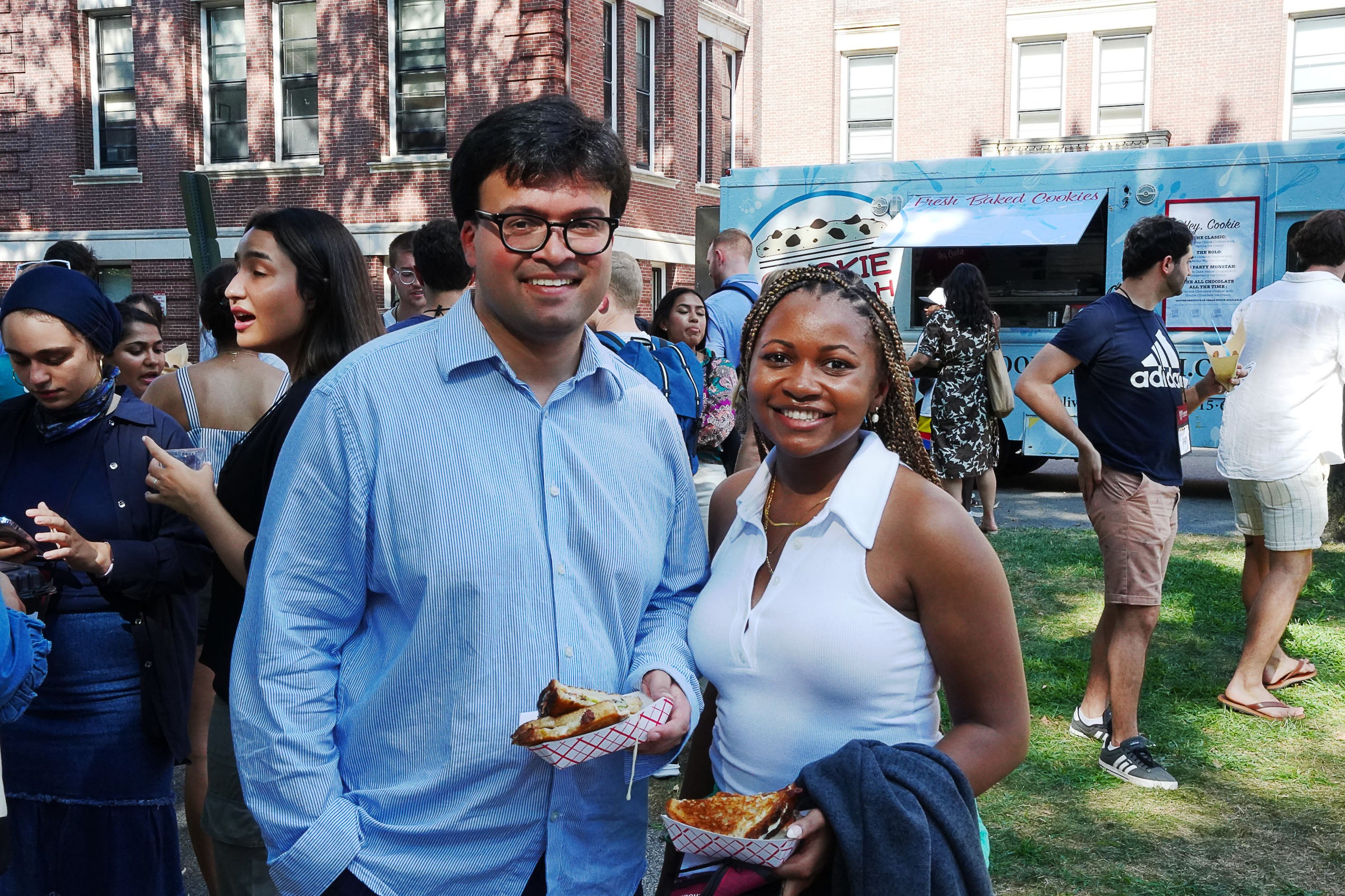 Two students outside, smiling for the camera.