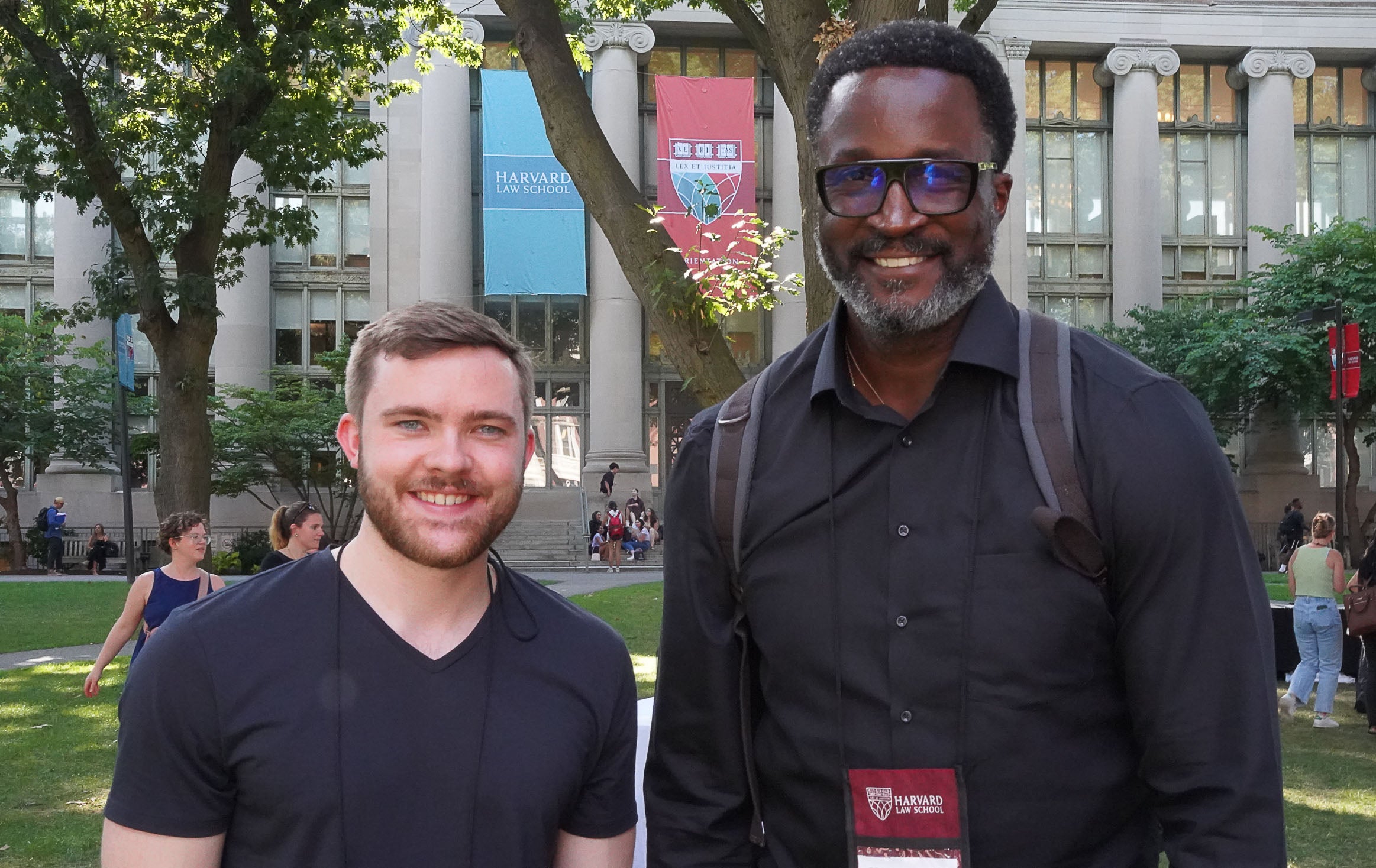 Two students standing outside, smiling for the camera.