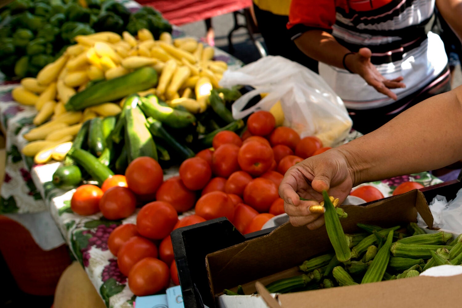 An assortment of vegetables on a table at a farmer's market.