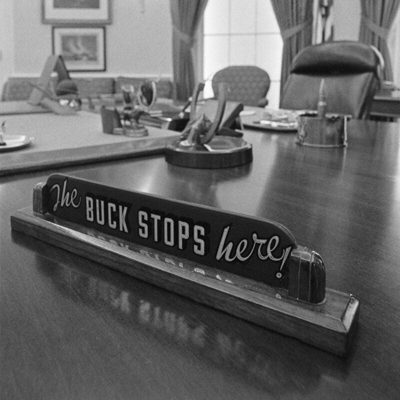Close up of The Buck Stops Here! sign on the desk of President Harry Truman.