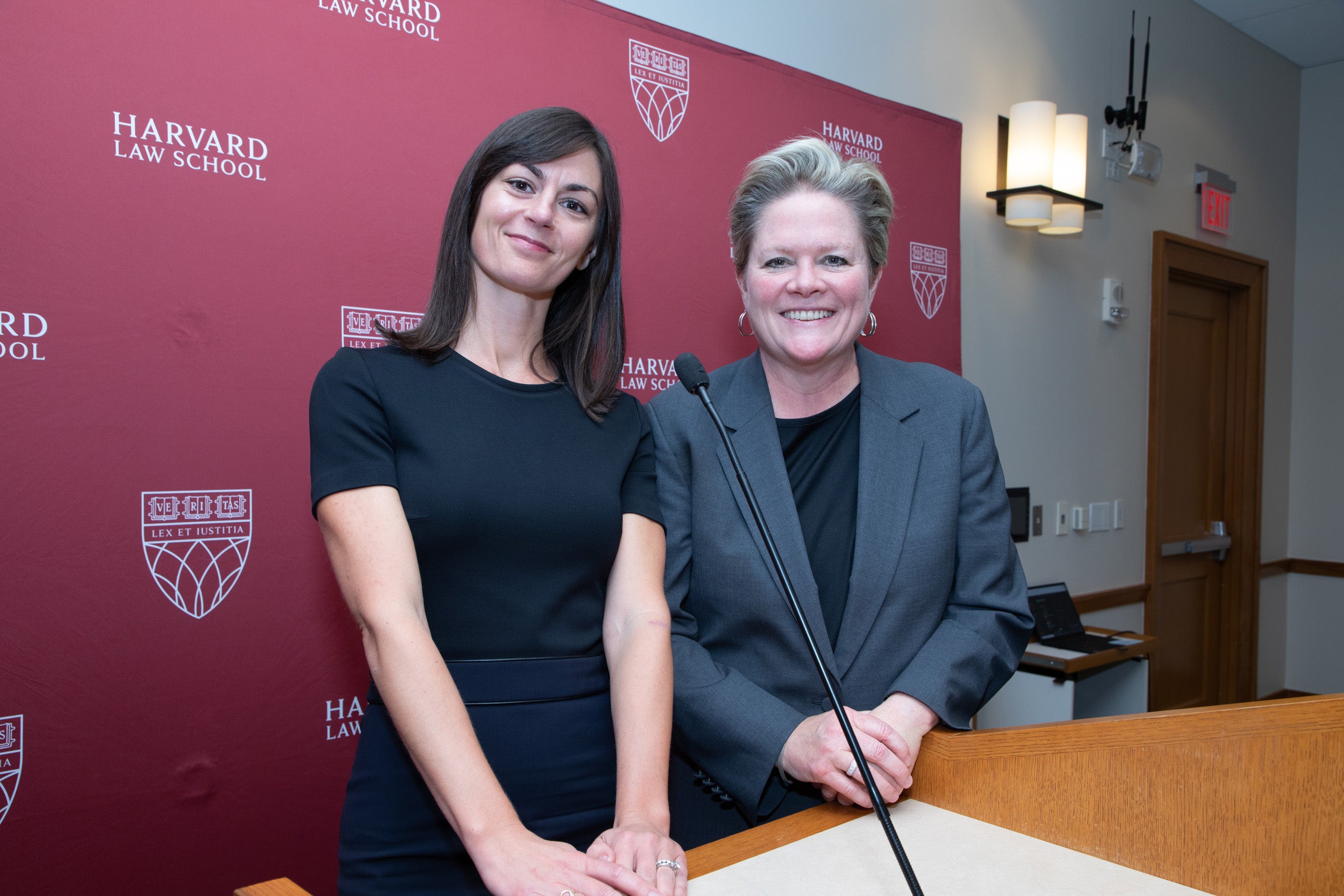 Two women standing at a podium
