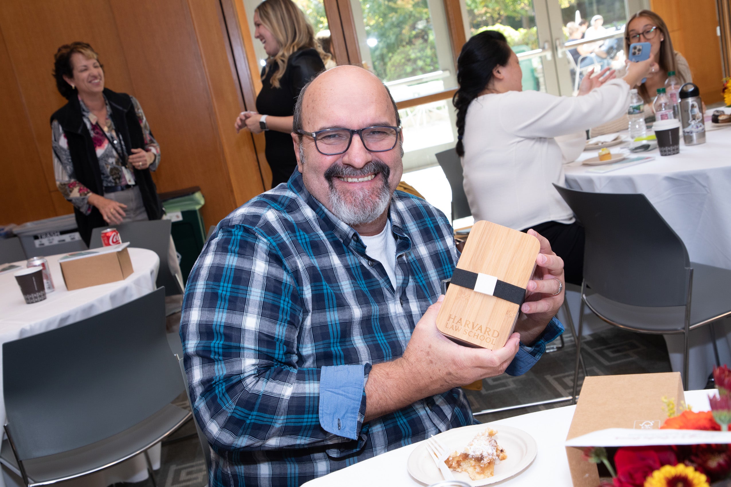 A man holding a bento box smiles