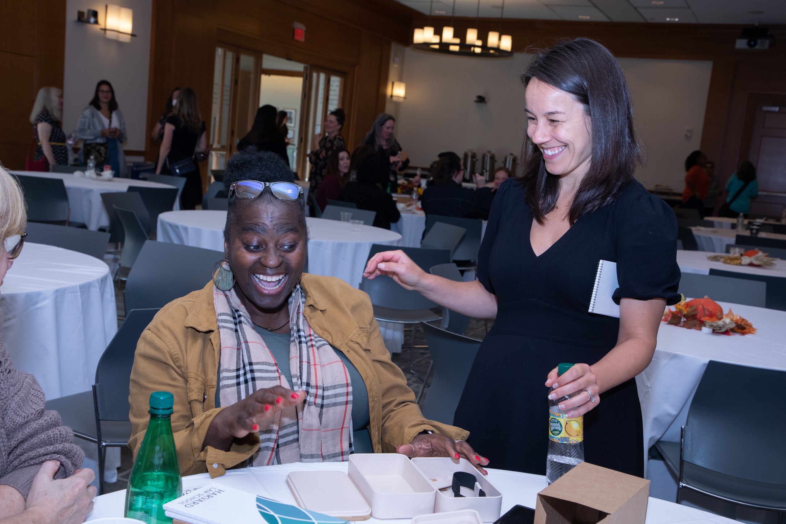 Two women enjoy a happy moment after opening a box