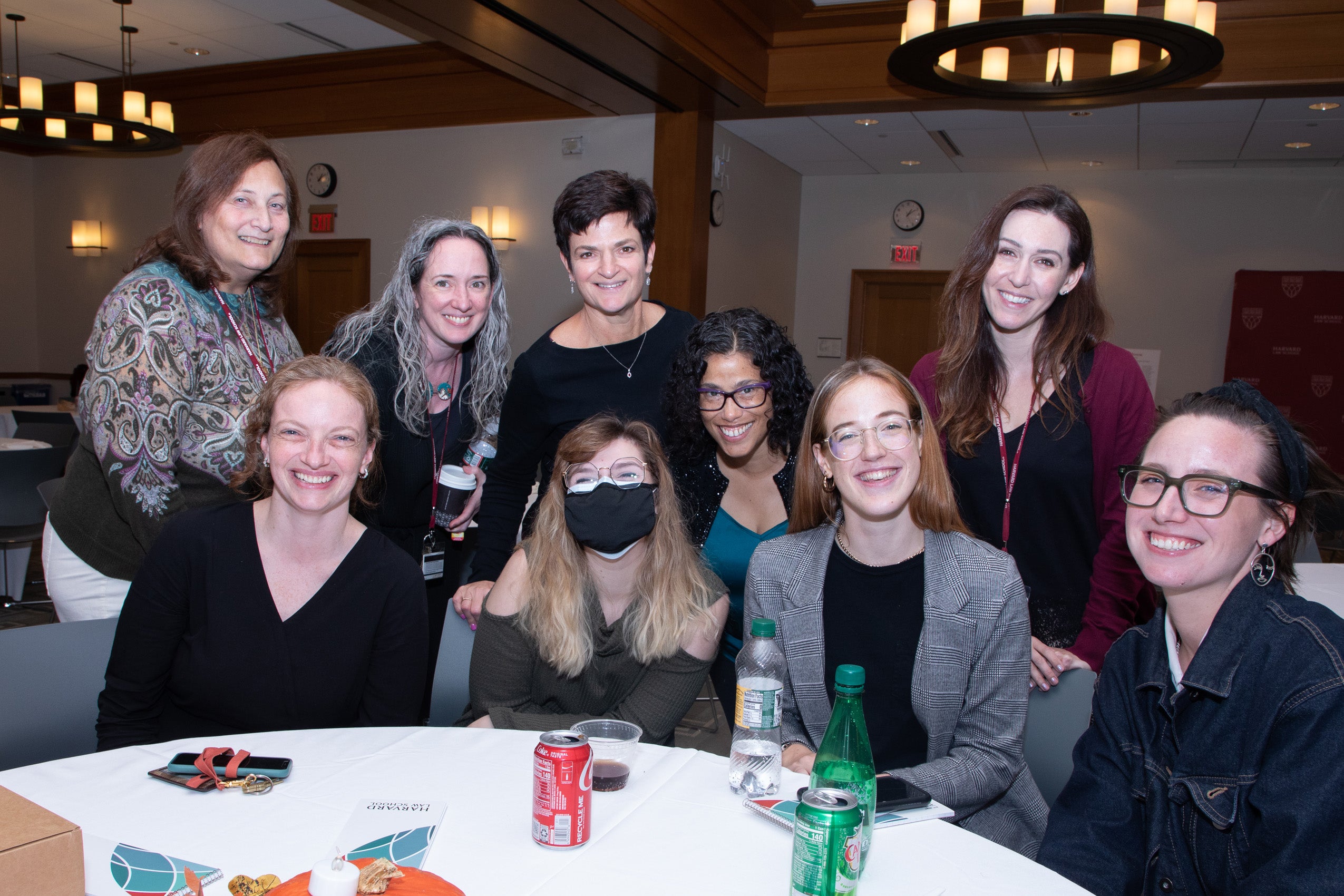 Nice people gathered at the end of a table for a group photo