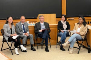 Panelists including Scott Westfahl, Michael Gregory, and Sabrineh Ardalan sit at the front of a classroom.